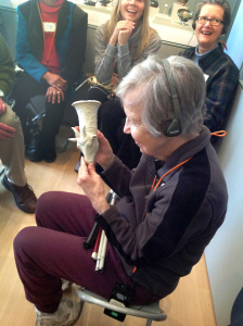 Tour participant with low vision touching the 3D printed Sheep Rhyton.