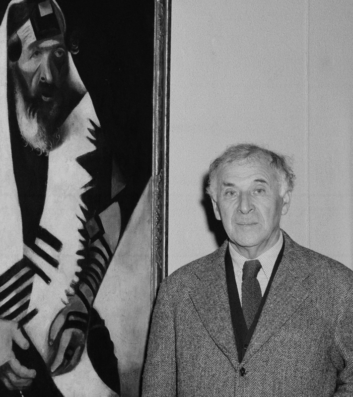 Photograph of Chagall with his painting <em>The Praying Jew</em> (1923), during his visit to the Art Institute of Chicago in 1946.