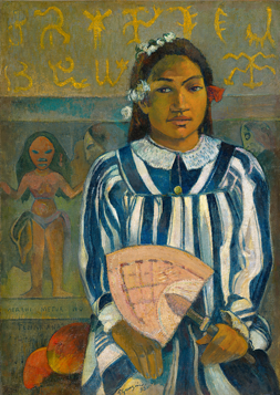 A young brown woman sits in a blue and white striped dress with a lace collar. Two mangoes rest beside her. She has white and red flowers in her hair and she holds a fan in the shape of a spade. In the background reads 'Merahi metua no Tehamana.'